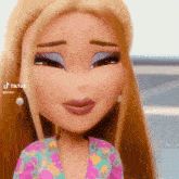 a close up of a bratz doll 's face with a floral shirt .