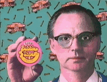 a man wearing glasses is holding a pink bubble tape in his hand