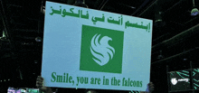 someone is holding up a sign that says smile you are in the falcons