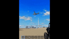 a person is holding a gun in front of a plane in the sky .