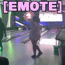 a woman in a bowling alley has the word emote above her head