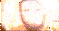 a blurred image of a person wearing a white mask with a hood