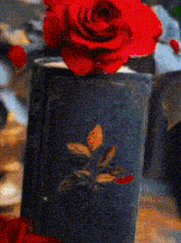 a red rose sits on top of a book