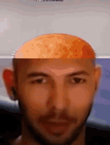 a close up of a man 's face with a half shaved head .