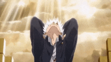 a man with his hands behind his head is looking up at the sky .