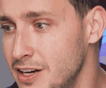 a close up of a man 's face with a beard and his mouth open