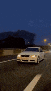 a car is driving under a bridge at night .