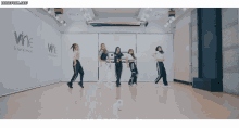 a group of young women are dancing in a dance studio with the words wine entertainment on the wall