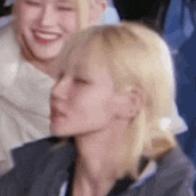 a close up of a woman 's face with a blurry background of another woman .