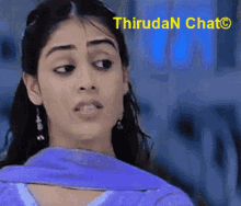 a close up of a woman 's face with the words thiruda n chat visible