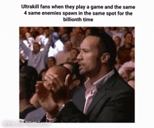 a group of people are sitting in a stadium watching a game and the rock is clapping .