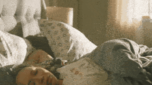 a woman sleeping in a bed with a shirt that says leo