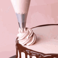 a cake being decorated by mr.cakes with chocolate drips