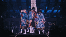 a girl is singing into a microphone while wearing a kimono
