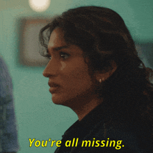 a woman says " you 're all missing " in yellow text