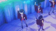 a group of people dancing in front of a blue wall