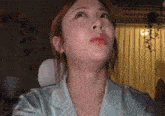 a close up of a woman 's face with her eyes closed .
