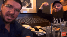 a man wearing a shirt that says all flexes his muscles