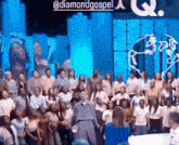a group of people are standing in front of a stage with a sign that says diamondgospel