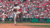 a phillies pitcher winds up to throw a baseball
