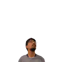 a man with a beard and glasses looks up at the number 16