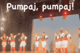 a group of men are dancing on a stage with the words pumpaj pumpaj