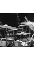 a black and white photo of a drummer playing drums