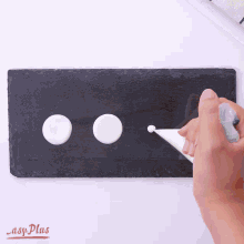 a person is piping white frosting on a slate cutting board with easy plus written on the bottom