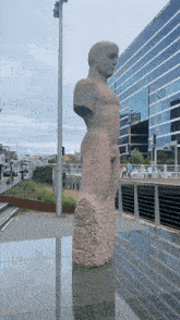 a statue of a man stands in front of a building that says ' pacific union bank ' on it