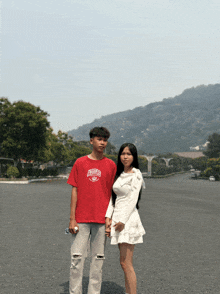 a boy wearing a red shirt with the word chicago on it stands next to a girl