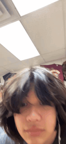 a person 's head is visible in front of a ceiling light and a shirt that says ' texas tech '