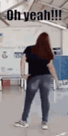 a woman is dancing in a room with the words `` oh yeah !!! '' written on the bottom .