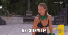 a woman in a bikini is sitting on a beach and says ne cujem te