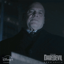 a man in a suit and tie is on a poster for daredevil born again