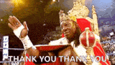 a wrestler is wearing a crown and a red robe and says thank you