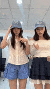 two women wearing blue hats that say jet wash walnut