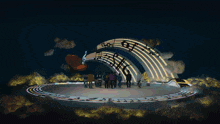 a group of people are dancing in front of a rainbow that says music on it