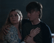 a man and a woman are hugging each other