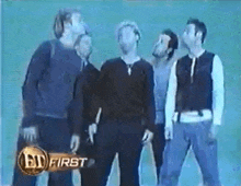 a group of men standing next to each other with ed first written on the bottom right