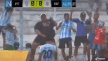a soccer player wearing a number 20 jersey is dancing in front of a crowd .
