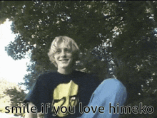 a boy is smiling in front of a tree with the words smile if you love himeko