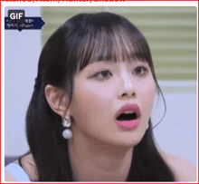 a close up of a woman 's face with her mouth open