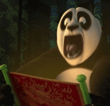a panda bear is reading a book with its mouth wide open