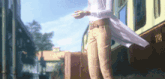 a woman in a white coat is standing next to a train with a suitcase