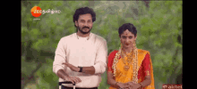 a man and a woman are standing next to each other on a screen that says zee hd on it