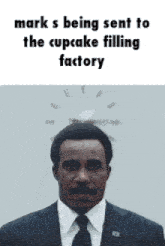 a man in a suit and tie says mark s being sent to the cupcake filling factory