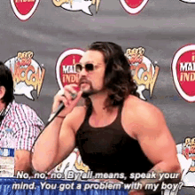 a man speaking into a microphone with the words " no no no by all means speak your mind you got a problem with my boy "