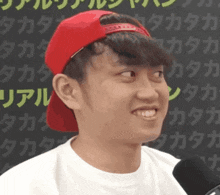 a young man wearing a red hat and a white shirt