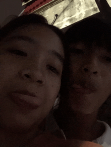 a boy and a girl are posing for a picture