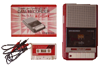 a nintendo data recorder sits next to a cassette tape and a manual